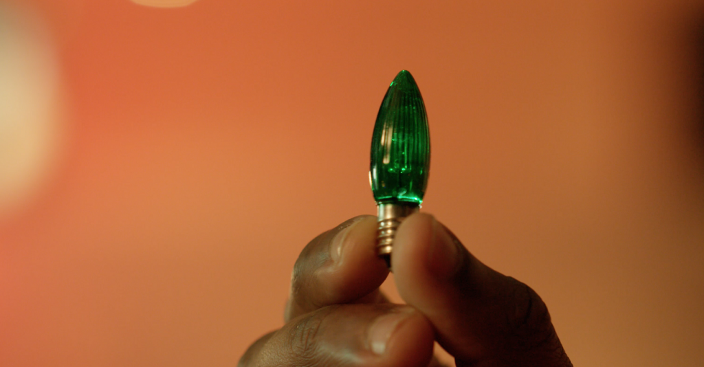 Still from AwareGO's Holiday Special security awareness video featuring a decorative string light