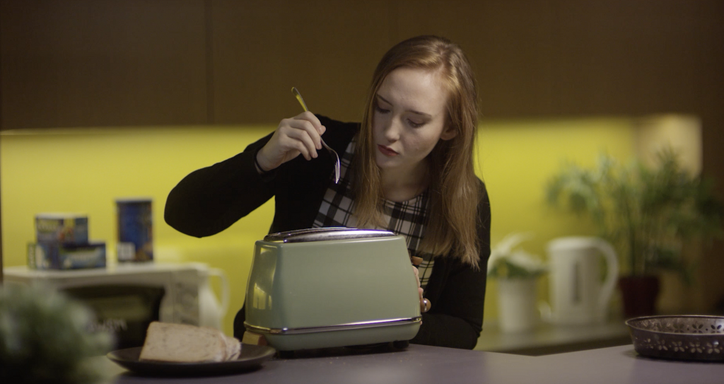 Woman about to put a fork into toaster, no security awareness here. This is why penetration testing and cybersecurity awareness go well together.