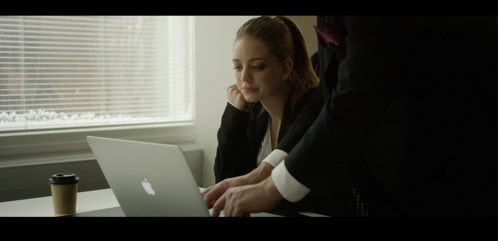 Man embodying a password manager types a password for a woman. A password manager stores and creates strong passwords and remembers them for you.