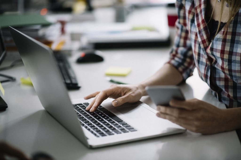 Millennial using messaging app such as Slack. AwareGO offers cyber security awareness training through Slack.