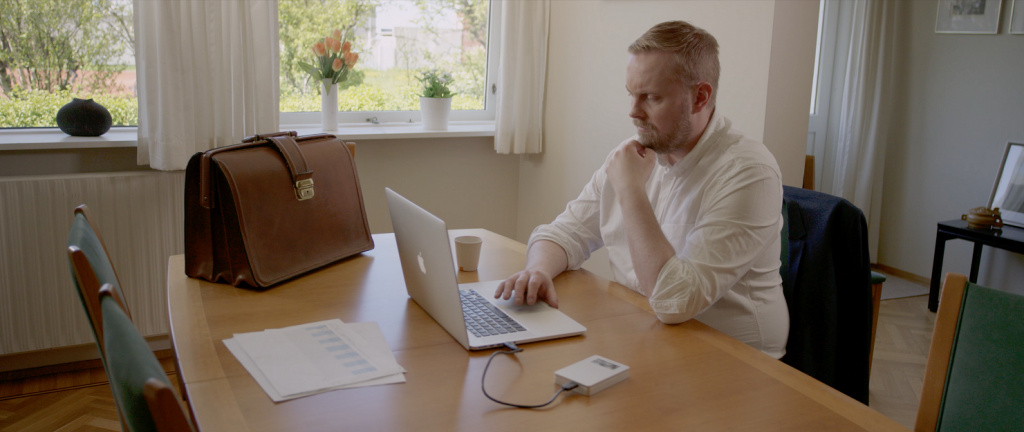 Man doing hybrid work and cybersecurity at home using movable media when he should use a secure cloud solution